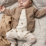 Heldragt til baby i hvid med beige teddybjørn-print, synlig med lange ben