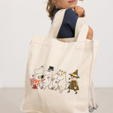 Creme shopper-taske med Moomin-figurer i forsideprint, bærehåndtag øverst