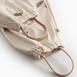 Beige baby regndragt med Moomin print, hætte og fodstropper