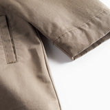 Detaljebillede af ærme og lommer på kaki chino frakke