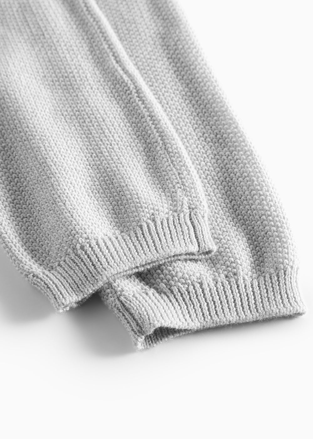 Detaljer af ribstrikket kant på grå babybukser