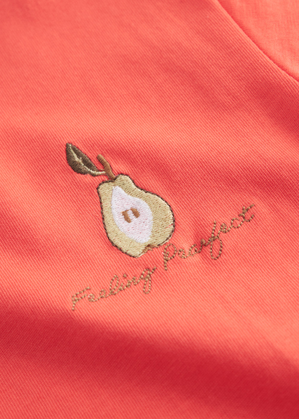 Orange børne-T-shirt med lille broderet frugtmotiv