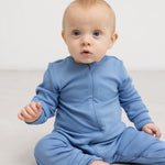 Lyseblå heldragt på baby med lynlås foran og lange ærmer, ribbet stof