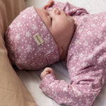 Lyserød bodystocking med små blomster og lange ærmer på baby