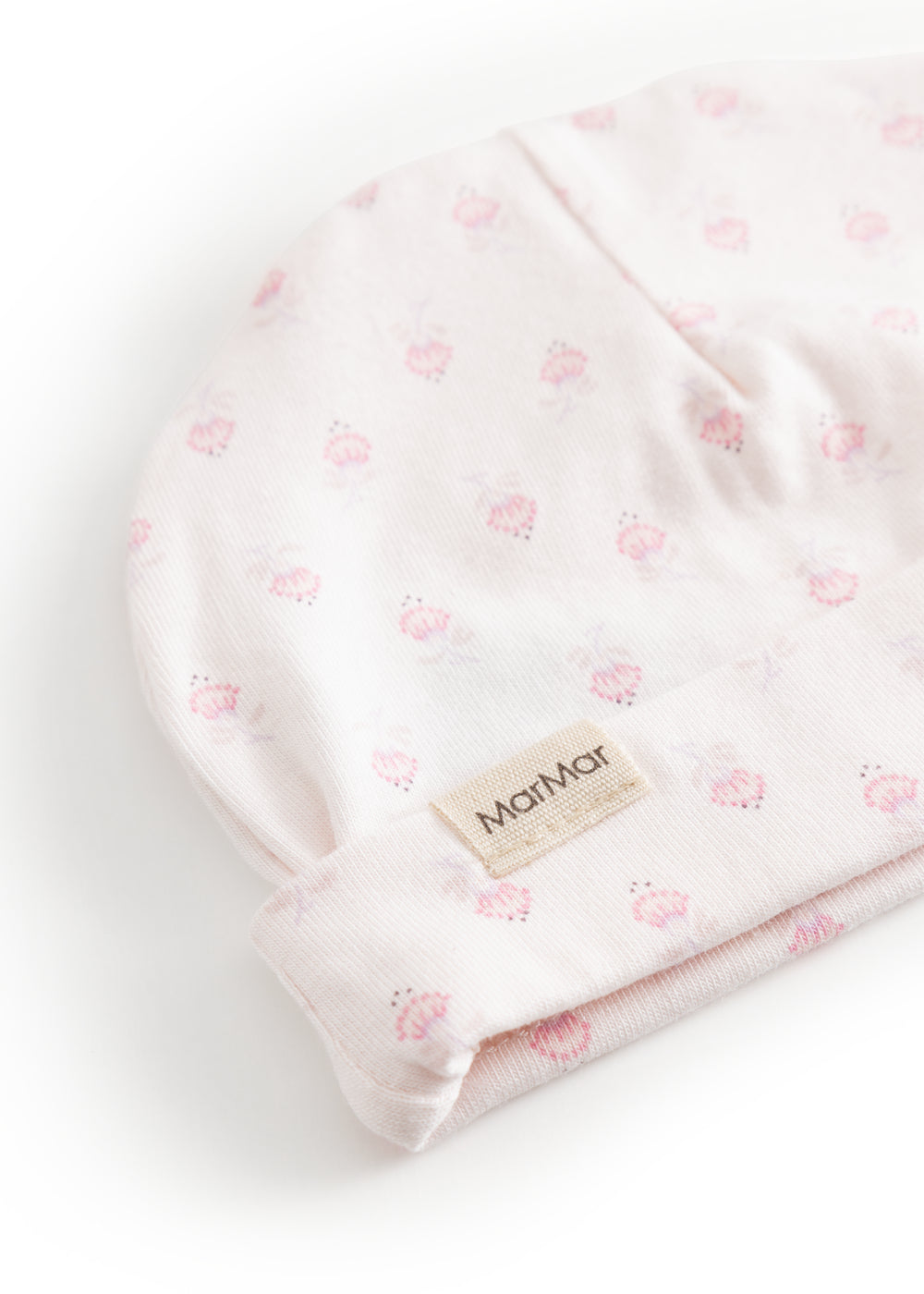 Babyhue med lyserødt blomsterprint og MarMar-mærke på stofetiket