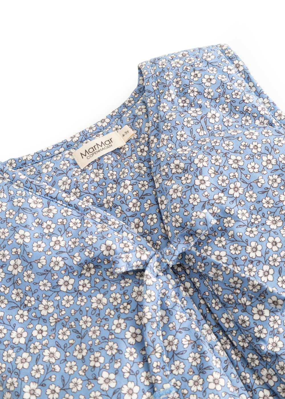 Blå blomstervest med hvide blomster og let fold i forstykke