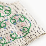 Prikket børnevest i creme med grøn blomstermønster og blå/lyserøde detaljer